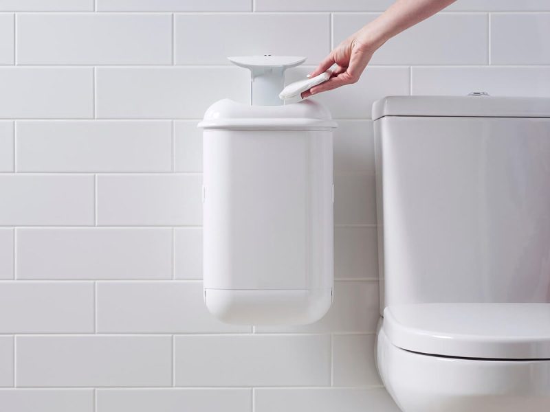A person disposing of sanitary waste in Pod Petite Auto Touch-free hygienic automatic sanitary bin