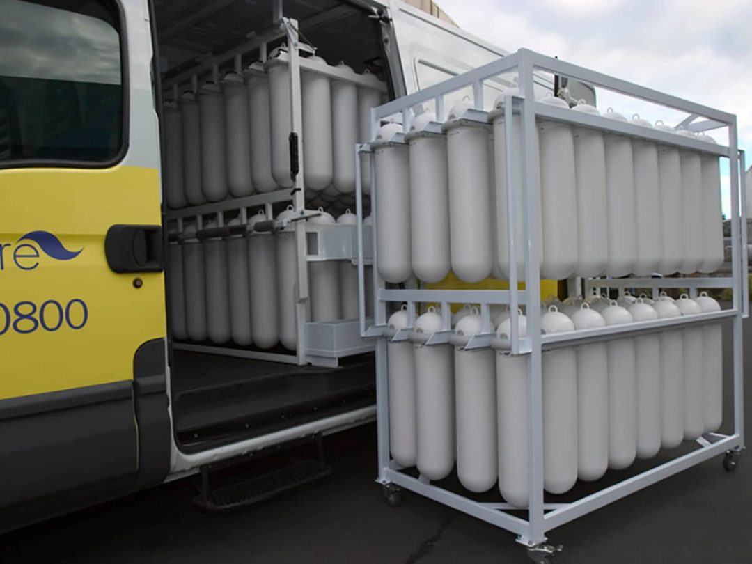 A hygiene service vehicle with SaniPod racking and a service trolley