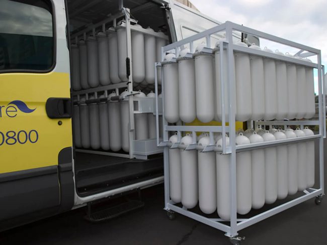 A hygiene service vehicle with SaniPod racking and a service trolley