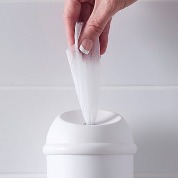 Wet Wipe White dispenser showing hand pulling out a antimicrobial wet wipe